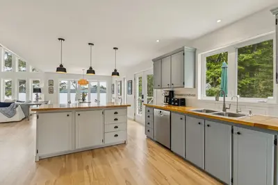 Kitchen with large window overlooking Lac-Simon — Chalet Beach House — Lac-Simon, Quebec