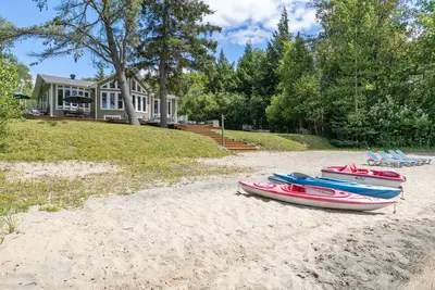 Water toys lined up on the private beach — Chalet Beach House — Lac-Simon, Quebec