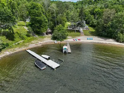 Private dock photographed by drone — Chalet Beach House — Lac-Simon, Quebec
